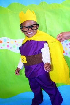 a little boy dressed up in a costume