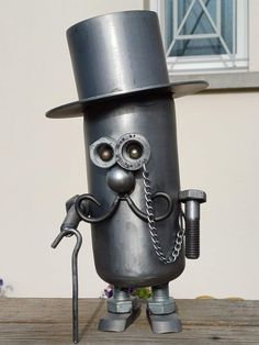 an odd looking metal object with a hat and eyeballs on it's head