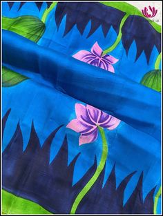 Bishnupuri Silk is a raw form of pure mulberry silk known for its soft, lightweight and smooth texture. They are originally from Bishnupur, a town in West Bengal, India. They come in vibrant colors. This very pretty blue and green Bishnupuri silk saree has hand-painted Buddha on the pallu. The borders feature painted small hand-painted Lotus pods. The saree is soft and very lightweight and easy to drape. It comes with an unstitched plain green blouse piece. Fall and Pico - Done Blouse - Unstitch Blue Art Silk Dupatta With Printed Motifs, Blue Katan Silk Saree With Kalamkari Print, Blue Art Silk Saree With Printed Motifs, Blue Block Print Tussar Silk Saree, Blue Raw Silk Saree With Kalamkari Print, Blue Silk Saree With Printed Motifs, Blue Block Print Tussar Silk Dupatta, Blue Chanderi Saree With Printed Motifs, Blue Katan Silk Dupatta With Kalamkari Print