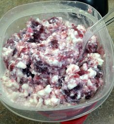 a bowl filled with blueberries and cream on top of a counter