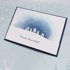 a christmas card with three houses on top of it and snowflakes in the background