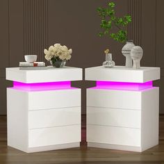 two white tables with purple lights on them