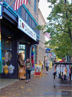 two people standing in front of a clothing store