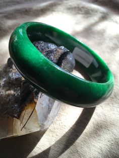 62.53 mm Swirly Green Moss Jadeite Bangle Bracelet #421 Size: 62.53 mm x 8mm x 18mm Weight: 72.61g = 363.05 Ct This is a weighty, solid piece of jade with some natural stone wen lines! Great starter bangle! Priced accordingly. Gem certificate included with purchase. Classic Jade Bracelets For Formal Occasions, Green Classic Bangle For Formal Occasions, Elegant Green Round Bangle, Classic Jade Bracelet Jewelry, Classic Jade Bracelet, Classic Green Gemstone Bracelets, Green Jade Bracelets For Formal Occasions, Classic Green Bangle Jewelry, Formal Jade Bangle Bracelet