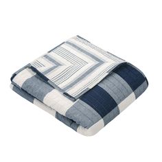 the blue and white blanket is folded up