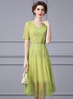 Joyous occasions call for a dress as delightful as this mother of the bride ensemble! Embrace the festivities in this light green dress that mirrors the freshness of a new beginning. Embellished with refined lace patterns and accented with a tastefully bejeweled waistline, this dress is a true work of art. The V-neck and short sleeves add a touch of modern sophistication, while the floaty skirt ensures you'll move with ease and confidence. Perfect for daytime ceremonies or evening receptions, this dress shines with a subtle sheen, promising to keep you in the spotlight without stealing the show. It's the ideal choice for the mother who stands proudly by her child, her attire a reflection of the love and pride that fills her heart. Green Short Sleeve Dress For Wedding, Spring Embellished Lace Mother Of The Bride Dress, Spring Lace Dress For Mother Of The Bride, Spring Mother Of The Bride Lace Dress, Elegant Green V-neck Mother Of The Bride Dress, Green Lace Dress For Summer Evening, Green Lace Dress For Summer, Green Lace Summer Dress, Green Embellished Spring Dresses