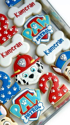 decorated cookies in the shape of letters and dogs