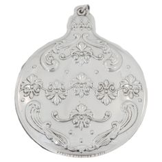 a silver locke with an ornate design on the front and back side, set against a white background