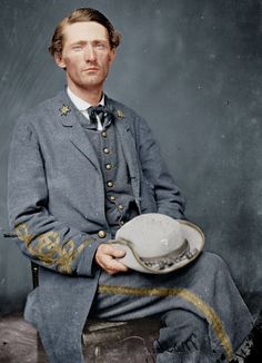 an old time photo of a man wearing a suit and tie with a hat on his lap