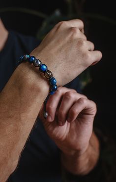 Men's Genuine Kyanite Crystal Bracelet. The handmade bracelet is made of 10 mm genuine Kyanite AA grade beads (blue), 10 mm 925 Sterling Silver bead (in the middle), 10 mm natural faceted Smoky Quartz bead (brown), and 10 mm natural flash Labradorite bead (grey). All finished with a black waxed cord, at the ends I used 8 mm natural flash labradorite beads as stoppers.  - The bracelet is adjustable and made in 20 cm (8 inches) size. It could be made in any size. - The bracelet is made of high-quality gemstones beads. - It would be a perfect gift for any occasion. - Shipping Worldwide from Munich, Germany. - To see other bracelets from LIMITED EDITION click: https://www.etsy.com/shop/Valinde?ref=seller-platform-mcnav&section_id=24387738 - if you want to see my other items click https://www.e Spiritual Blue Adjustable Sterling Silver Bracelet, Kyanite Bracelet, Kyanite Crystal, Luxury Bracelet, Silver Bead Bracelet, Braided Bracelet, Bracelet Blue, Labradorite Beads, Blue Kyanite