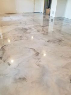 an empty room with marble floors and white walls