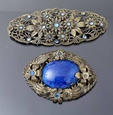 These 2 brooches are very pretty. I was informed that they are both Neiger Bros pieces  and I believe that to be the case - but as I am no expert on their pieces, I will leave it up to you decide. Both pieces are in brass - detailed floral built up design. From the top - This brooch is an 'eye' shape in design and features a vivid Lapis glass central cabochon. Four raised floral sections - each holding a sapphire blue paste/glass. Good condition. Old style wide 'c' clasp on back. Pin is slightly Vintage Blue Brooches For Jewelry Making, Blue Victorian Brooch For Formal Occasions, Victorian Blue Brooch For Formal Occasions, Blue Victorian Brooches For Formal Occasions, Ornate Blue Brooch For Formal Occasions, Ornate Blue Brooches For Wedding, Ornate Blue Wedding Brooches, Formal Blue Handmade Brooches, Antique Blue Collectible Brooches