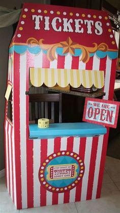 a red and white striped carnival ticket booth