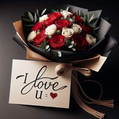 a bouquet of roses is sitting next to a card with the word i love u written on it