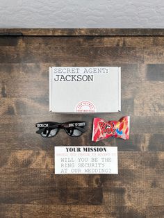 an assortment of personal items displayed on top of a wooden table, including sunglasses and card