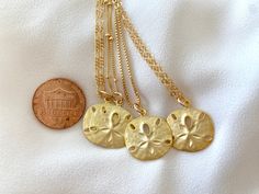 **Each piece in my shop, I personally create and photograph. (All photos are property of The Cord Gallery LLC) Thank you for supporting my small business. These stunning Medallion Necklaces are perfect stand alone and layering pieces. Features a Sand Dollar Coin Medallion with lots of rustic texture and interest. Made from Matte Gold Vermeil (18k Gold plated over 925 Sterling Silver).*Pendants measure 18mm in diameter (including bail)Hangs on your choice of chain:Gold Filled Link ChainGold Fille Sand Dollar Pendant, Rustic Texture, Gold Sand, Dollar Coin, Medallion Necklace, Sand Dollar, Chain Gold, Silver Pendants, Gold Filled Chain