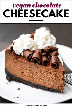 a piece of chocolate cheesecake on a white plate with whipped cream and chocolate shavings