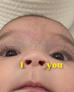 a close up of a baby's face with the words i you on it