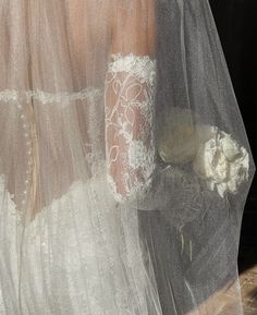 the back of a bride's wedding dress and veil