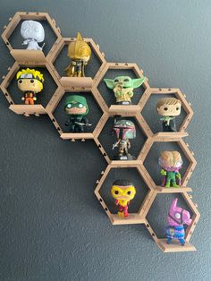 a bunch of toy figurines are arranged in hexagons on the wall