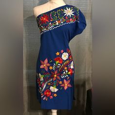 This Is A Beautifully Embroidered Dress With Amazing Colors That Match Perfectly With The Royal Blue!! One Shoulder Makes It Look Gorgeous, Elegant And Sexy. Comes With Straps On Each Side So You Can Tie And Adjust To Your Body And Comfort And Slits On Each Side. Size M New Without Tags Made In Mexico Blue Floral Print Embroidered Summer Dress, Summer Blue Embroidered Floral Print Dress, Spring Blue Embroidered Mini Dress, Blue Embroidered Cotton Mini Dress, Blue Floral Embroidered Beach Dress, Blue Floral Embroidered Dress For Beach, Blue Floral Embroidery Dress For Beach, Blue Cotton Dress With Floral Embroidery, Sleeveless Blue Mini Dress With Floral Embroidery