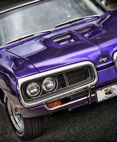 the front end of a purple muscle car