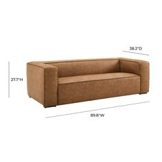 a brown couch sitting on top of a white floor