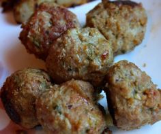 a white plate topped with meatballs on top of a wooden table next to an instagram page