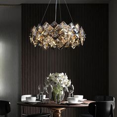 a dining room table with chairs and a chandelier hanging from it's ceiling