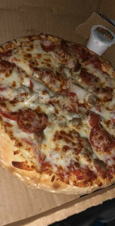 a pizza sitting on top of a cardboard box