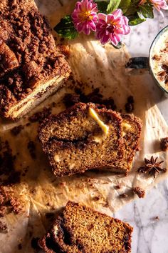 slices of cinnamon bread sitting on top of a table next to a bowl of granola