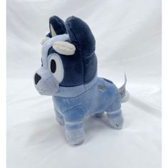 a small stuffed animal that is blue and has an ear on it's head