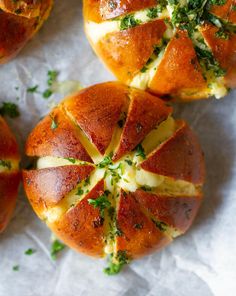 several pieces of bread with cheese and herbs on them