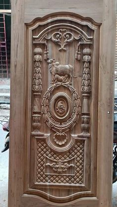 an intricate carved wooden panel on the side of a building