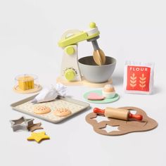 an assortment of toys including a mixer, cookie sheet and baking utensils