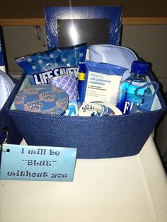 a blue basket filled with personal care items sitting on top of a white countertop