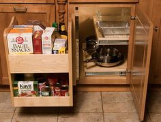 an open cabinet in the middle of a kitchen with spices and condiments on it