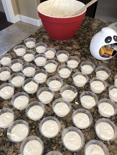 there are many cupcakes on the counter ready to be baked in the oven