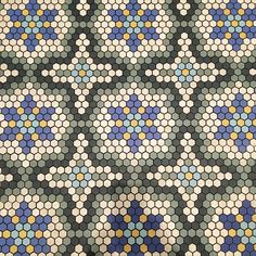 an abstract mosaic pattern with blue, yellow and white dots