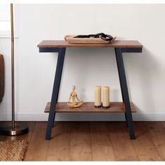 a wooden table with candles on it next to a chair