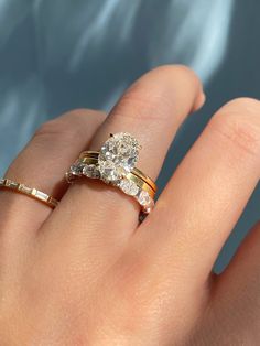 a woman's hand with two rings on it and one ring in the middle