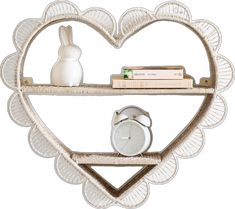 a heart shaped shelf with a clock and some books