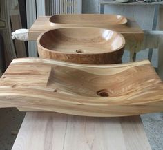 three wooden bowls sitting on top of a table