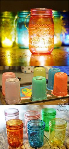 several different colored glass jars sitting on top of a table