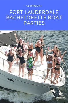 a group of women in bathing suits standing on the back of a boat with their arms up