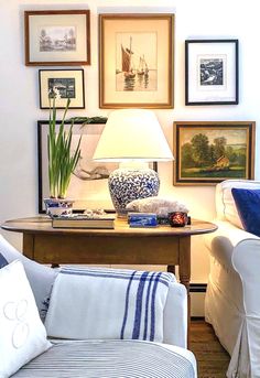 a living room filled with furniture and pictures on the wall above it's coffee table