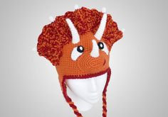 an orange and white knitted hat with horns on it's head is shown