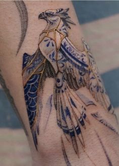 a tattoo on the arm of a woman with an eagle and moon in her hand