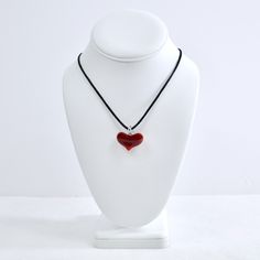 This Murano Glass Mini Heart Pendant Necklace is sure to leave you with an everlasting impression! Boasting a tasteful mini red Murano glass heart pendant on a smooth black silk cord, this Italian-made necklace will have you feeling like a million bucks (not that you don't already). Fused glass heart with clear glass loop. Lobster clasp with adjustable chain at the end of the silk cord. Small heart measures: 1" wide x 1" tall (including glass loop) Large heart measures: 1.5" wide x 1.25" tall (i Heart Shaped Jewelry With Adjustable Cord As Gift, Red Adjustable Heart Necklace As A Gift, Adjustable Red Heart Necklace As A Gift, Adjustable Red Heart Necklace For Gift, Adjustable Red Heart Necklace Gift, Heart Shaped Necklace With Adjustable Cord As Gift, Adjustable Cord Heart Pendant Jewelry Gift, Adjustable Red Necklaces With Heart Charm, Valentine's Day Glass Necklaces Gift