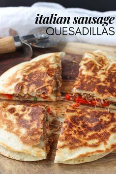 a pizza cut into eight pieces on a cutting board with the title italian sausage quesadillas